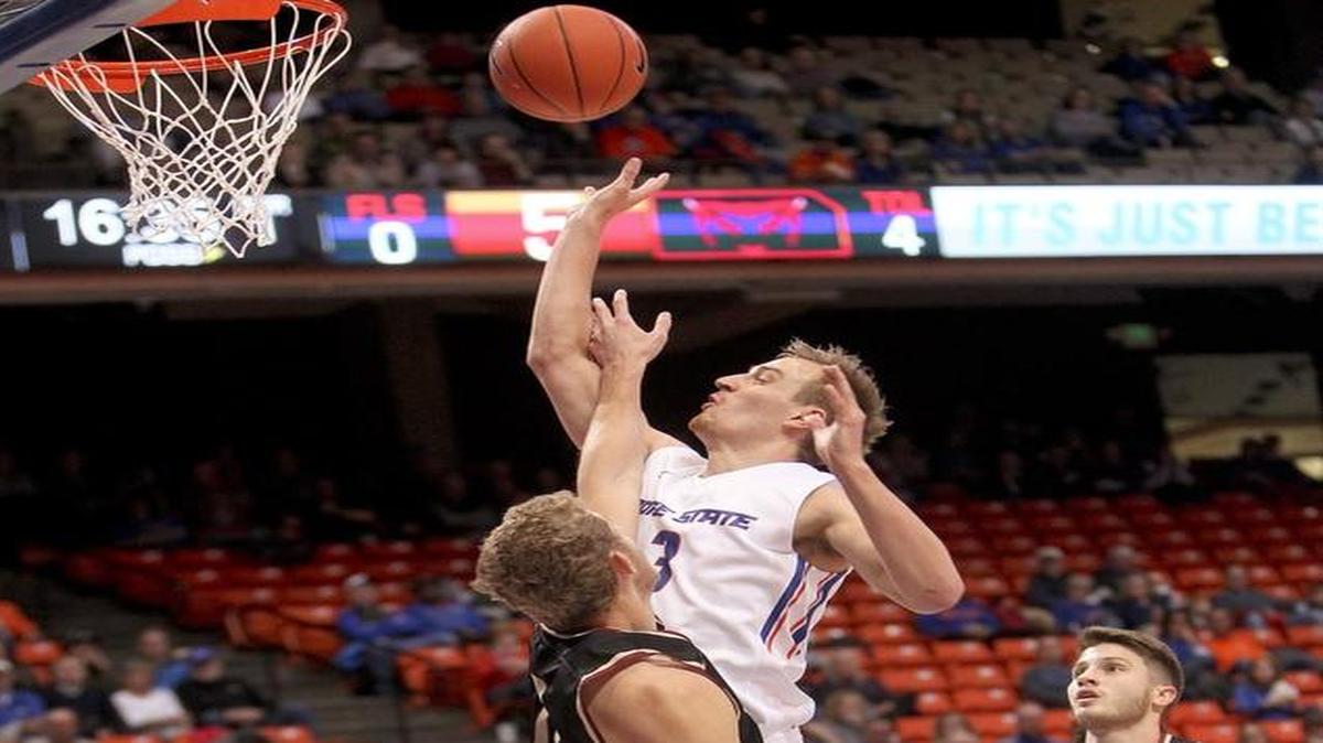 Boise State Broncos guard guard Anthony Drmic (3) scores over Willamette Bearcats forward Brandon Luedtke (0) during the first half of a nonconference men’s basketball game Dec. 2, 2015, at Taco Bell Arena in Boise, Idaho.
