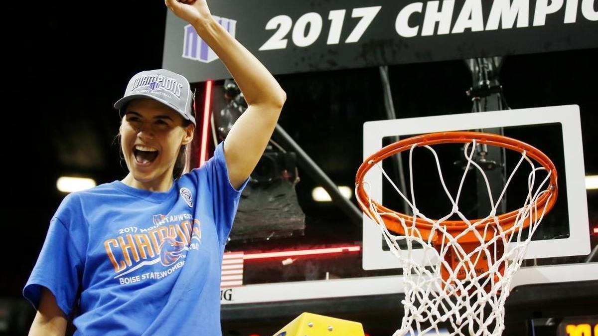 Boise State senior basketball player Brooke Pahukoa cuts a piece of the net after the Broncos defeated Fresno State on March 10, 2017, to win the Mountain West Tournament in Las Vegas.