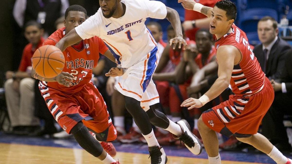 Boise State’s Mikey Thompson dribbles through a Fresno State double team during the 2014-15 season.