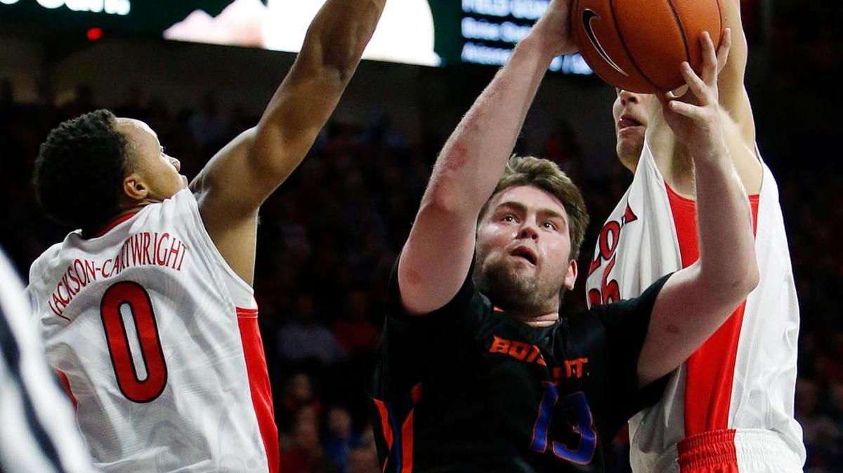 Boise State forward Nick Duncan (13) drives between Arizona guard Parker Jackson-Cartwright, left, and Kaleb Tarczewski during the first half of an NCAA college basketball game, Thursday, Nov. 19, 2015, in Tucson, Ariz.