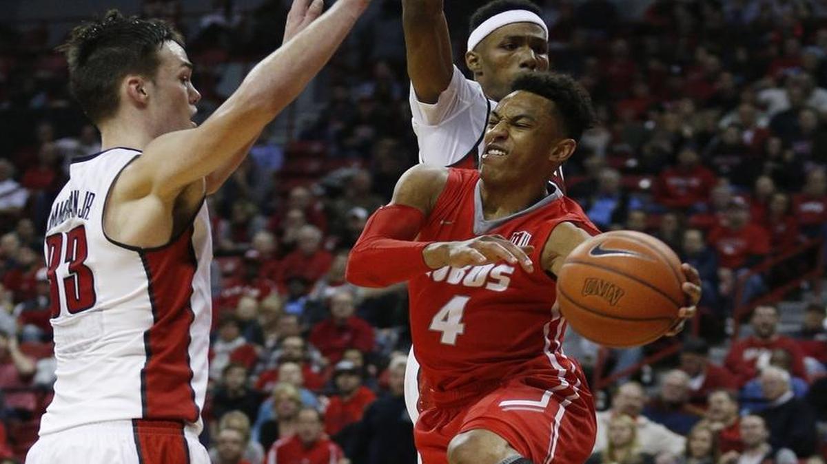 New Mexico guard Elijah Brown passes around UNLV forward Stephen Zimmerman Jr., left, during the first half of their game Tuesday in Las Vegas. Brown leads the Lobos in scoring average.
