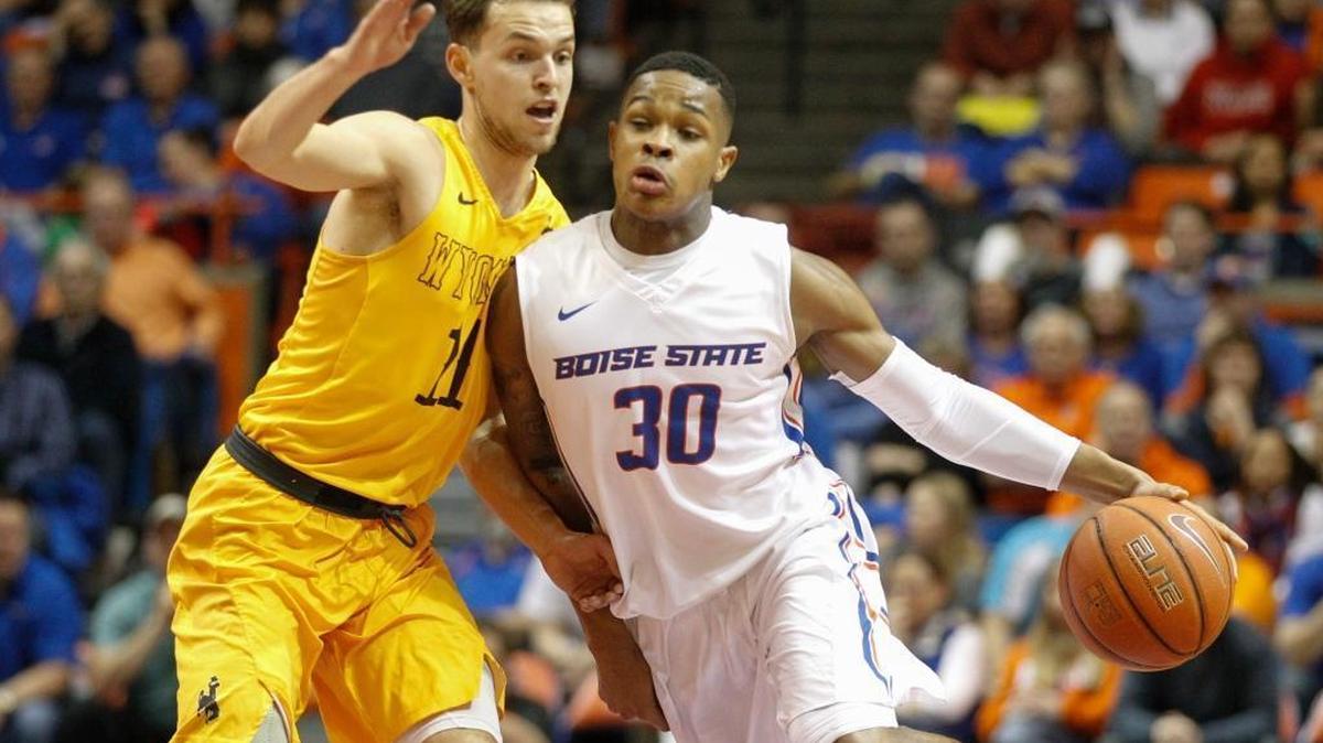 Boise State’s Paris Austin drives around Wyoming’s Jeremy Lieberman during their game in Boise on Feb. 18, 2017.