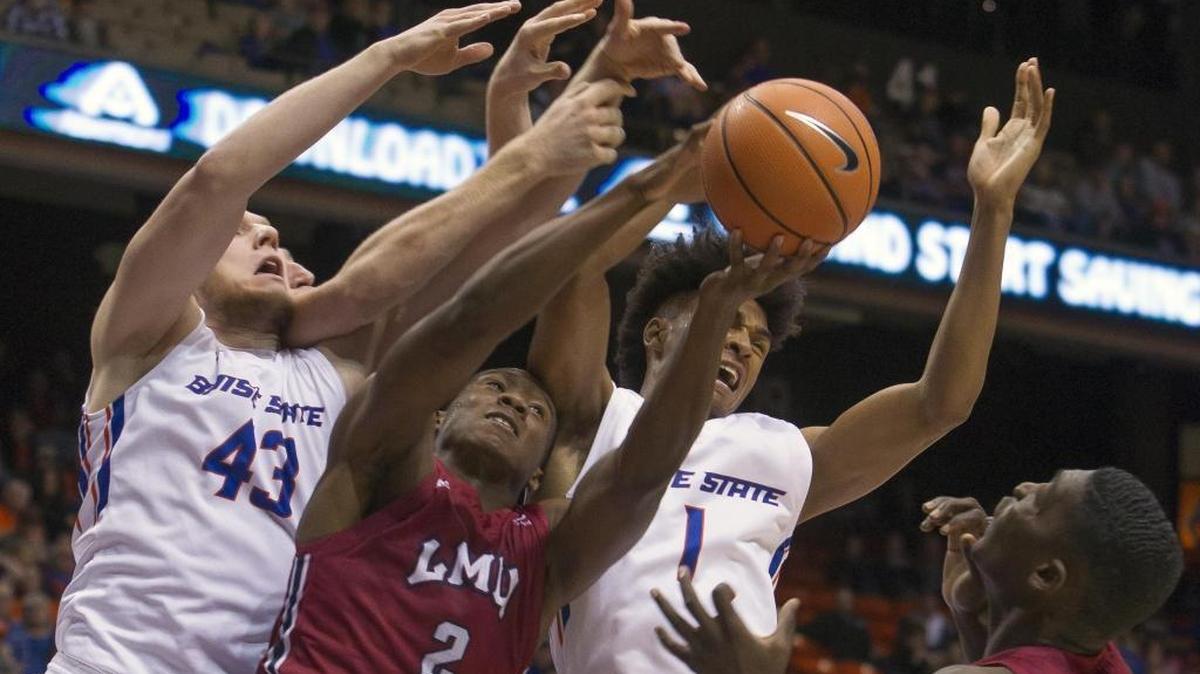Boise State’s Cam Christon (1) and Chris Sengfelder (43) fight for a rebound with Loyola Marymount forward Donald Gipson in the second half Saturday at Taco Bell Arena in Boise.