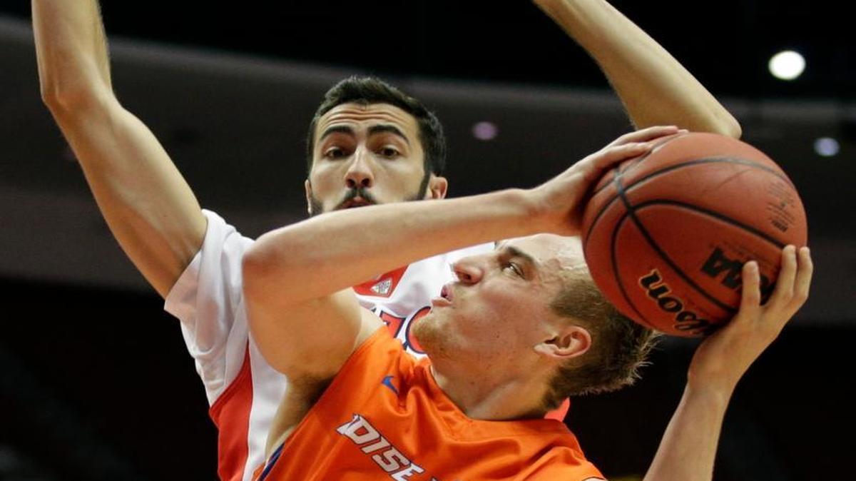 Boise State guard Anthony Drmic, front, looks to shoot as he is defended by Arizona forward Mark Tollefsen during the first half of an NCAA college basketball game at the Wooden Legacy tournament, Sunday, Nov. 29, 2015, in Anaheim, Calif. (AP Photo/Jae C. Hong)