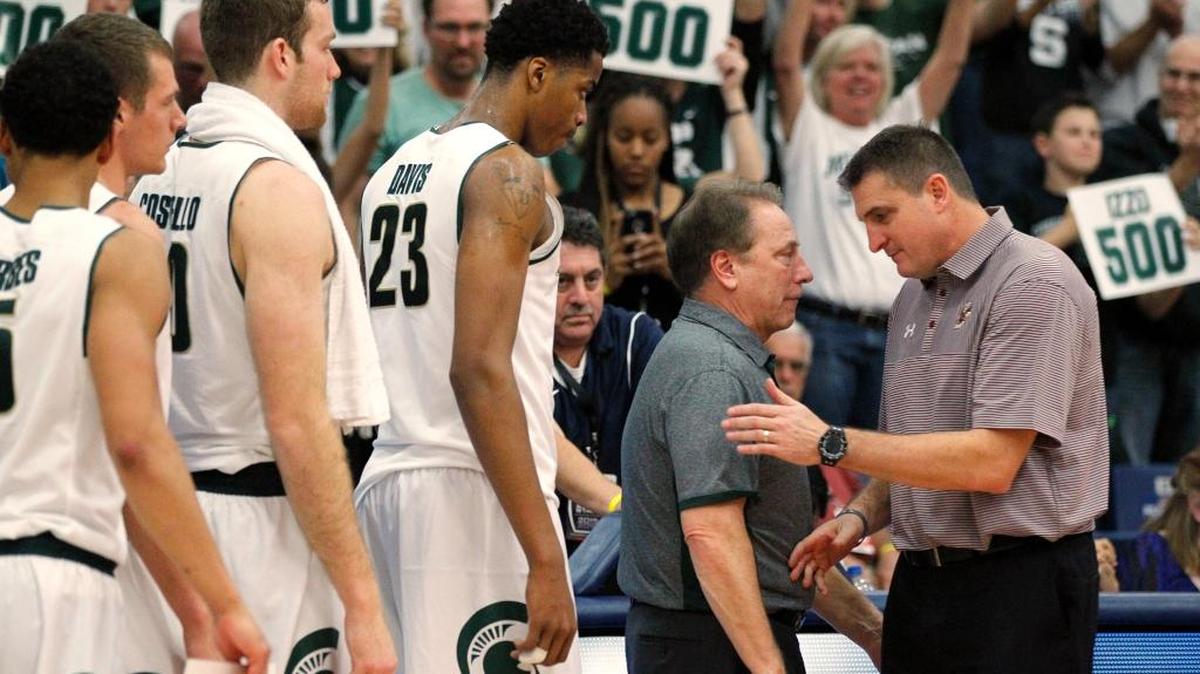 Michigan State coach Tom Izzo, left, is congratulated by Boston College coach Jim Christian after Izzo won his 500th career game Thursday. Michigan State won 99-68 in the opening game of the Wooden Legacy tournament.