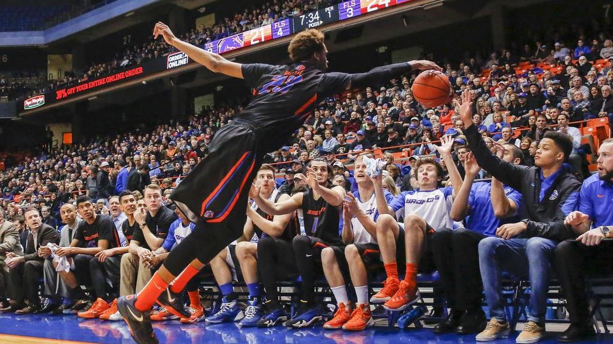 Boise State’s James Webb III tries to stop a ball from going out of bounds during the first half Tuesday against Utah State at Taco Bell Arena. Boise State won 70-67.