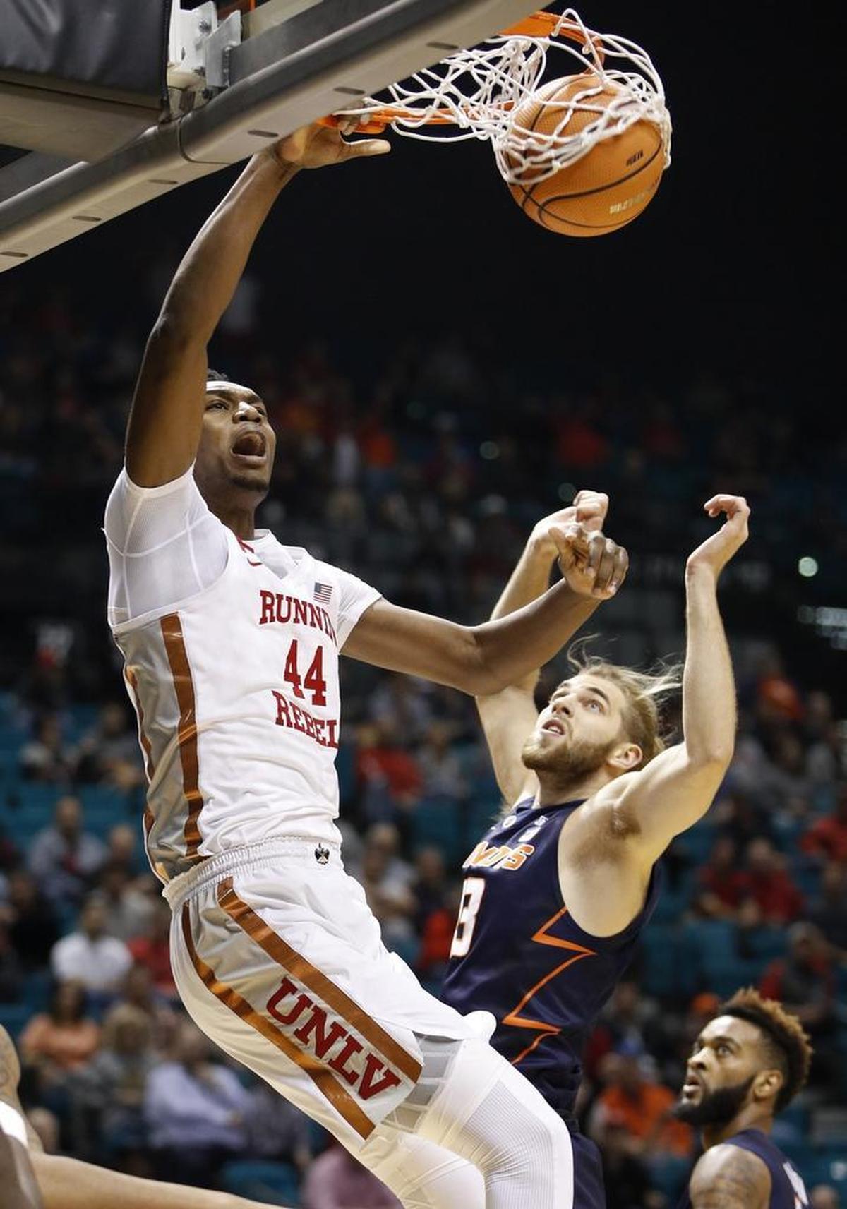 UNLV freshman Brandon McCoy dunks over Illinois’ Michael Finke on Dec. 9 in Las Vegas. McCoy leads the Mountain West in scoring at 18.9 points per game.