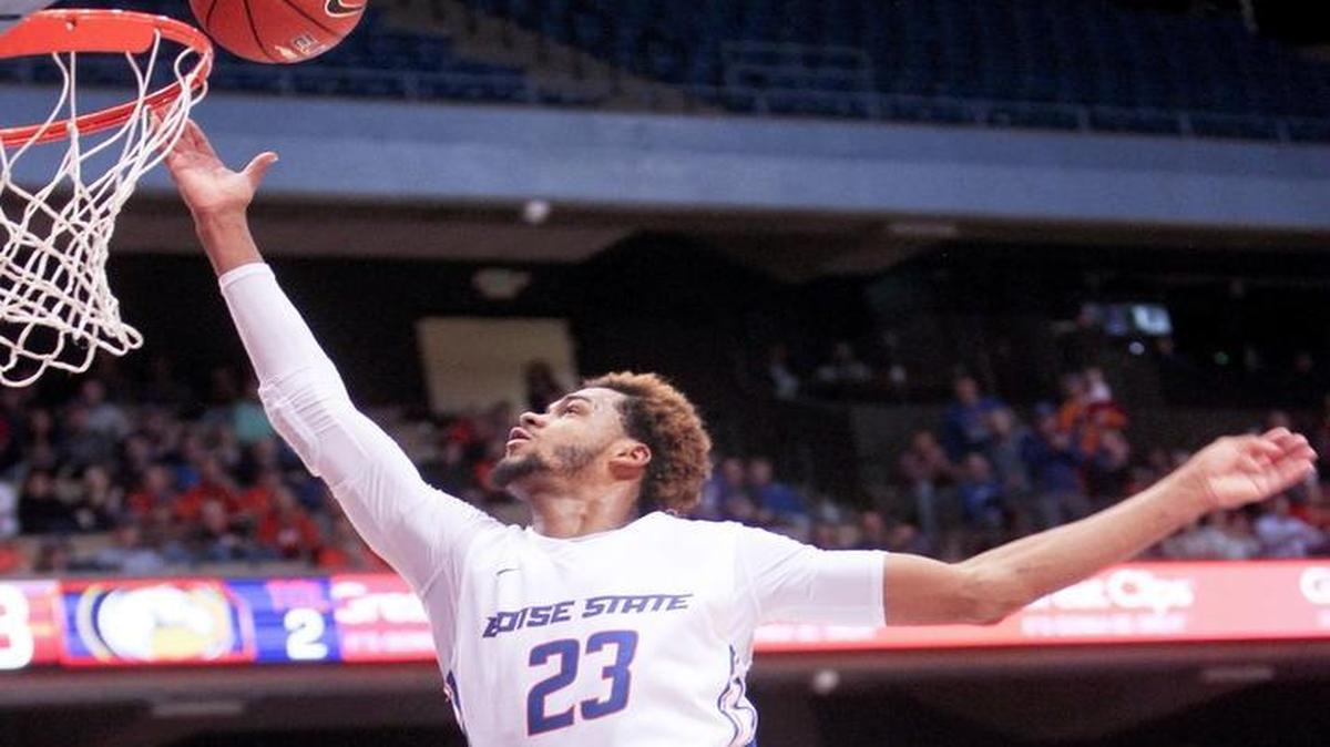 Boise State guard-forward James Webb III (23) scores and gets fouled by UC Davis guard Lawrence White (1) during the second half of a nonconference men’s basketball game Wednesday, Dec. 30, 2015, at Taco Bell Arena. Boise State defeated UC Davis 64-56.