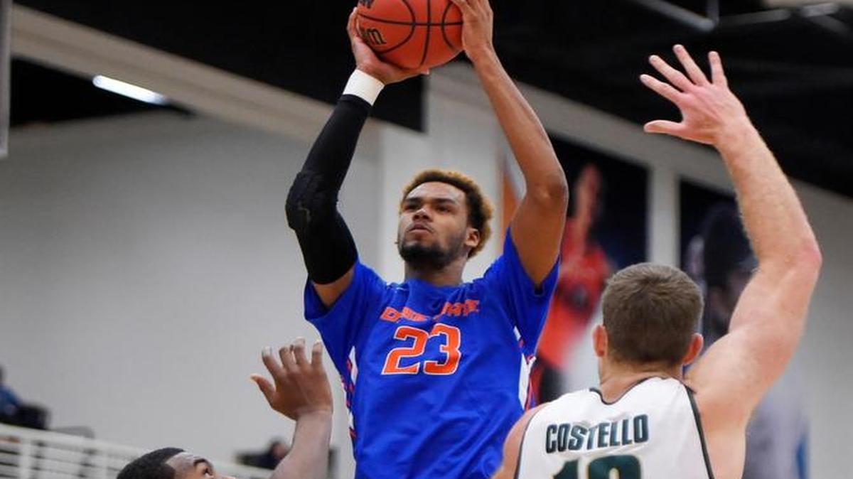 Boise State forward James Webb III, center, shoots as Michigan State forward Javon Bess, left, and forward Matt Costello defend during the first half Friday at the Wooden Legacy tournament in Fullerton, Calif.