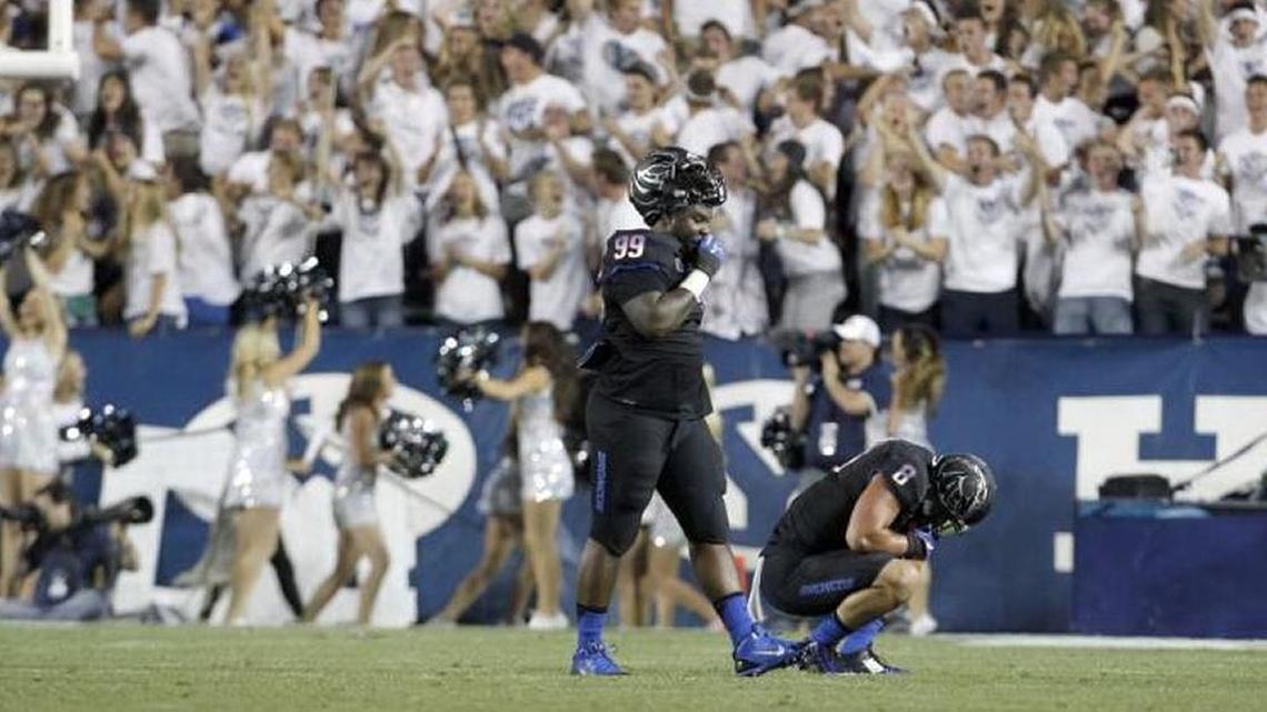 Boise State defensive linemen Dereck Boles (99) and Kamalei Correa (8) react after BYU scored in the final minute to go ahead Sept. 12, 2015 in Provo, Utah. Boles was dismissed from the team Saturday.