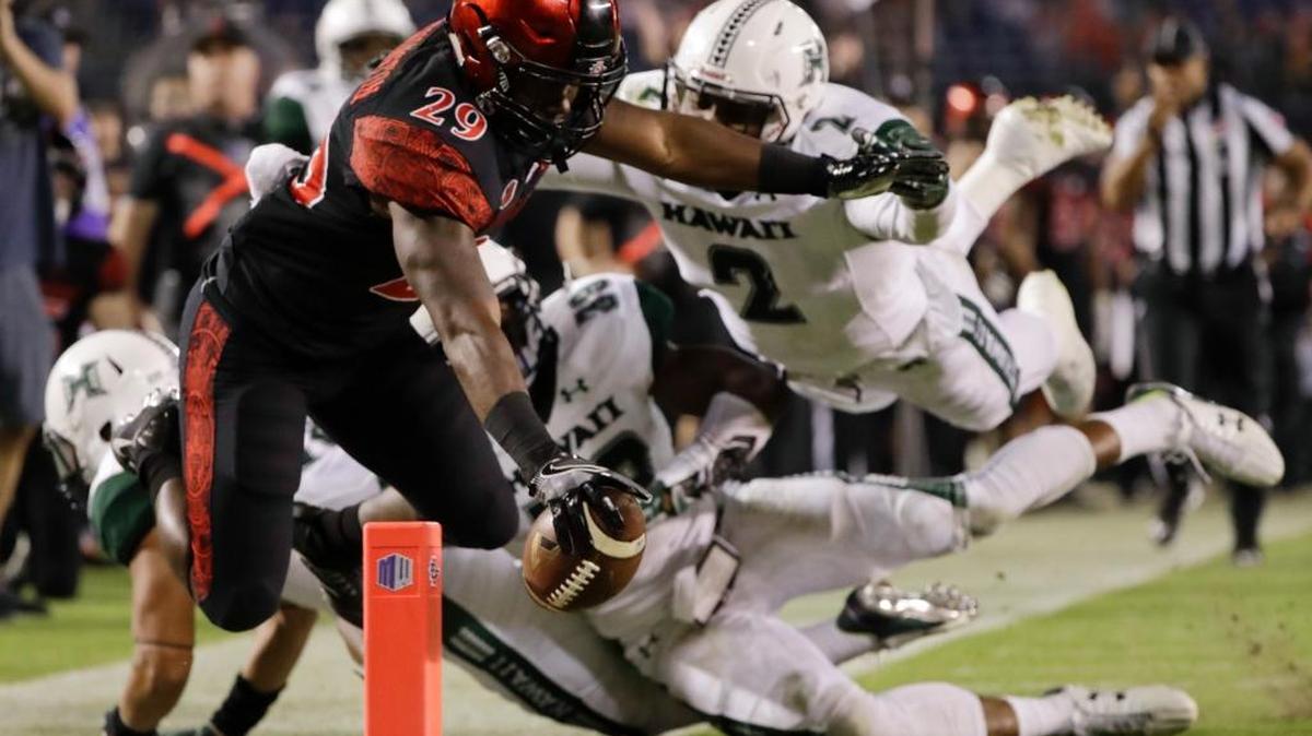 San Diego State running back Juwan Washington dives into the end zone for a touchdown during the second half of a college football game against Hawaii on Saturday, Nov. 5, 2016, in San Diego.