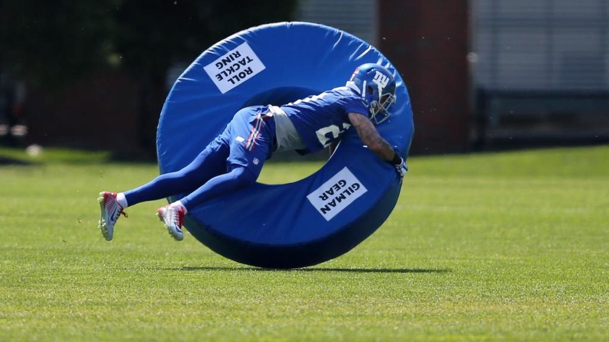 New York Giants safety Darian Thompson (27) dives on a tackle ring during practice in East Rutherford, N.J. on May 23.