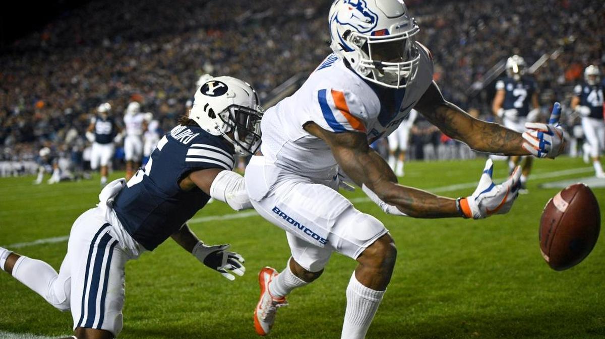 Boise State wide receiver Cedrick Wilson can’t quite get his hands on a potential touchdown catch as BYU’s Dayan Ghanwoloku closes in Friday at LaVell Edwards Stadium in Provo, Utah.