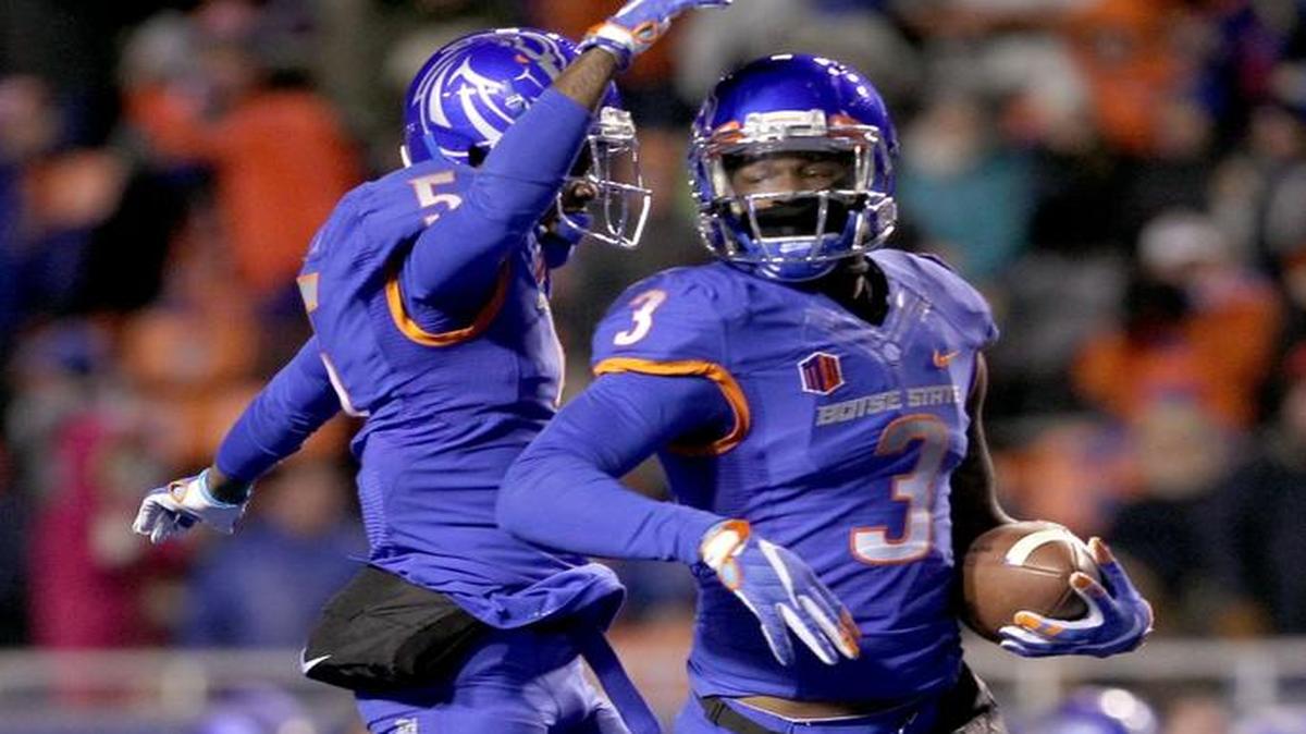 Boise State safety Chanceller James celebrates his third quarter interception with teammate Donte Deayon in the Broncos' game against Air Force Friday Nov. 20, 2015 at Albertsons Stadium in Boise.