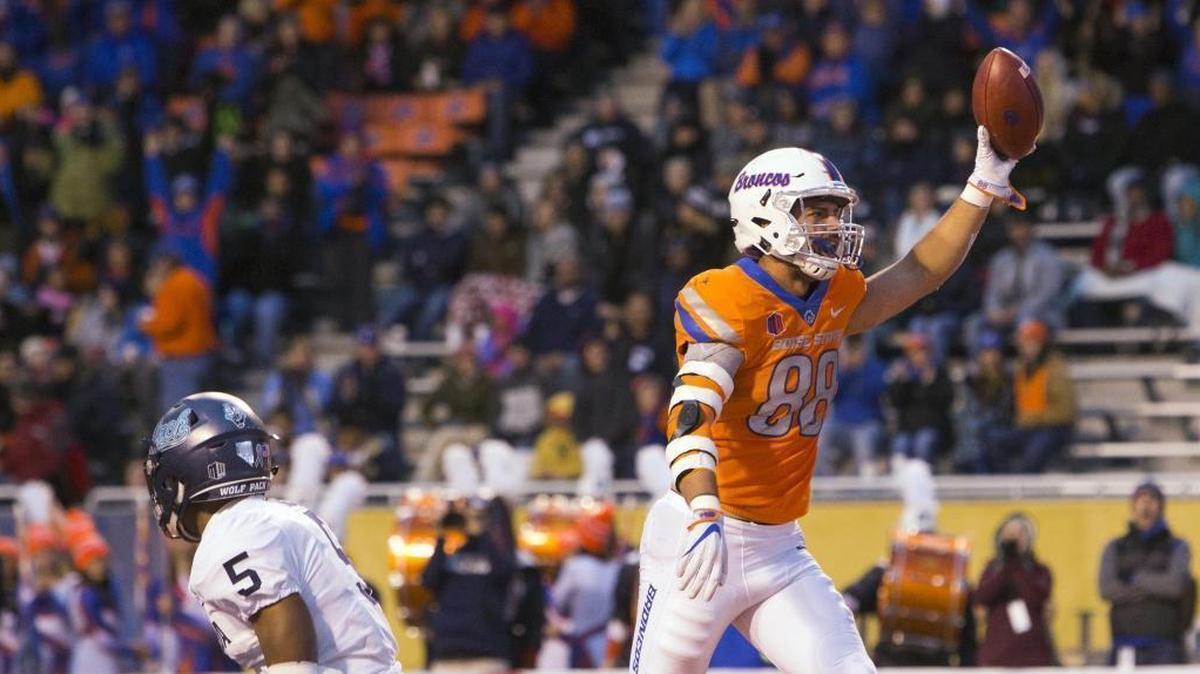 Boise State tight end Jake Roh celebrates his second-quarter touchdown as Nevada defensive back Dameon Baber gets off the ground Saturday at Albertsons Stadium in Boise.