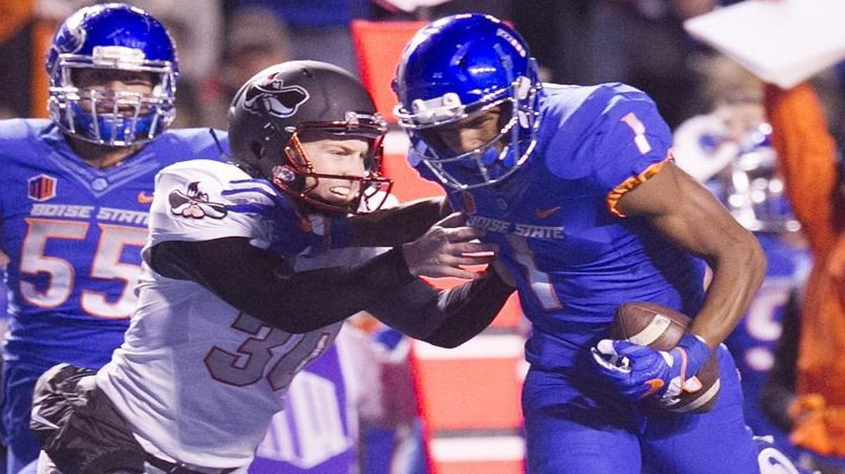 UNLV kicker Evan Pantels (30) gets enough of Boise State wide receiver Cedrick Wilson (1) to bring him down after a 73-yard punt return during a Mountain West college football game at Albertsons Stadium in Boise, Idaho, on Friday, Nov. 18, 2016.