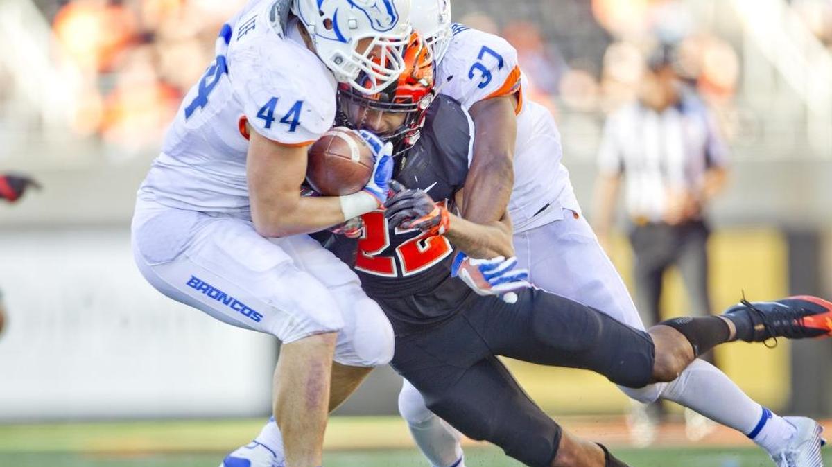 Boise State linebacker Darren Lee (44) strips the ball from Oregon State wide receiver Seth Collins (22) before returning it 19 yards for a touchdown Saturday at Reser Stadium in Corvallis, Ore. Boise State Broncos safety Cameron Hartsfield (37) is also in on the play. Boise State defeated Oregon State 38-24.