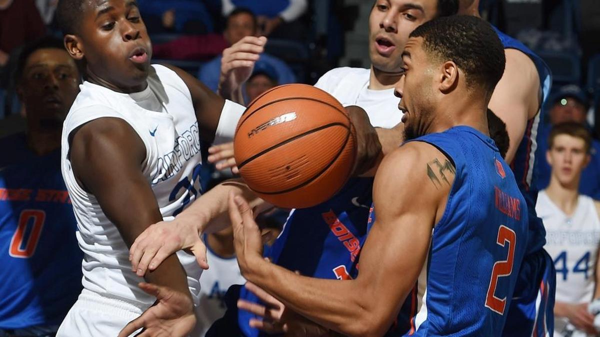 Air Force guards Trevor Lyons and Caleb Morris fight for the ball against Boise State guard Lexus Williams (left to right).