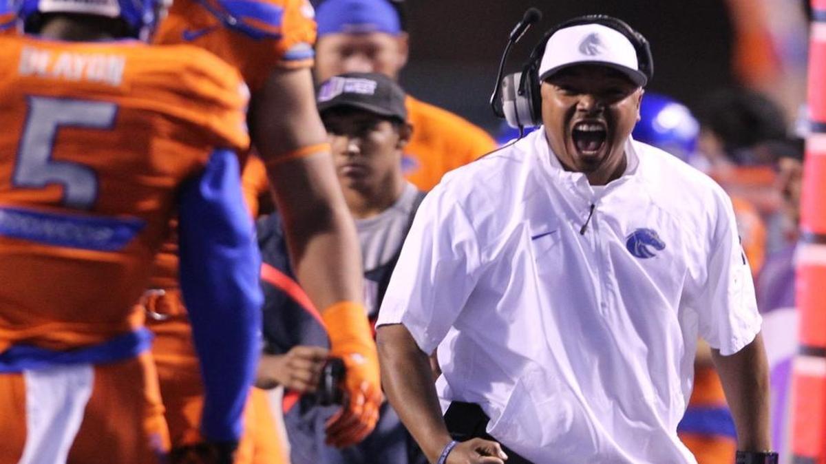 Boise State secondary coach Julius Brown celebrates a sack by Boise State cornerback Donte Deayon (5) against Fresno State on Oct. 17, 2014, at Albertsons Stadium.