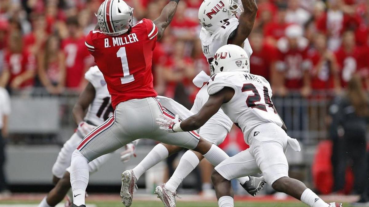 Northern Illinois cornerback Shawun Lurry, top right, intercepts a pass in front of Ohio State wide receiver Braxton Miller during their game at Ohio Stadium in Columbus, Ohio, on Saturday, Sept. 19, 2015. The Buckeyes won 20-13.