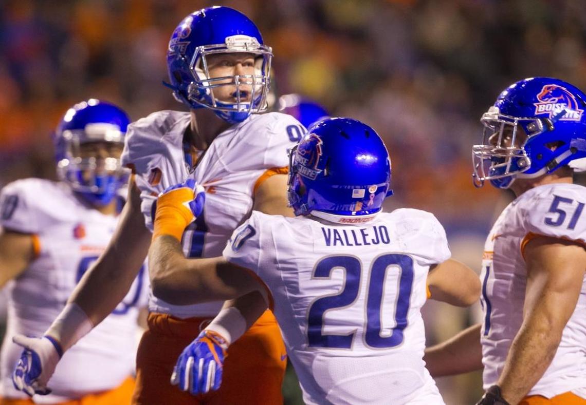 Boise State defensive end Durrant Miles celebrates a sack with teammate Tanner Vallejo (20) during last year’s game against Colorado State.