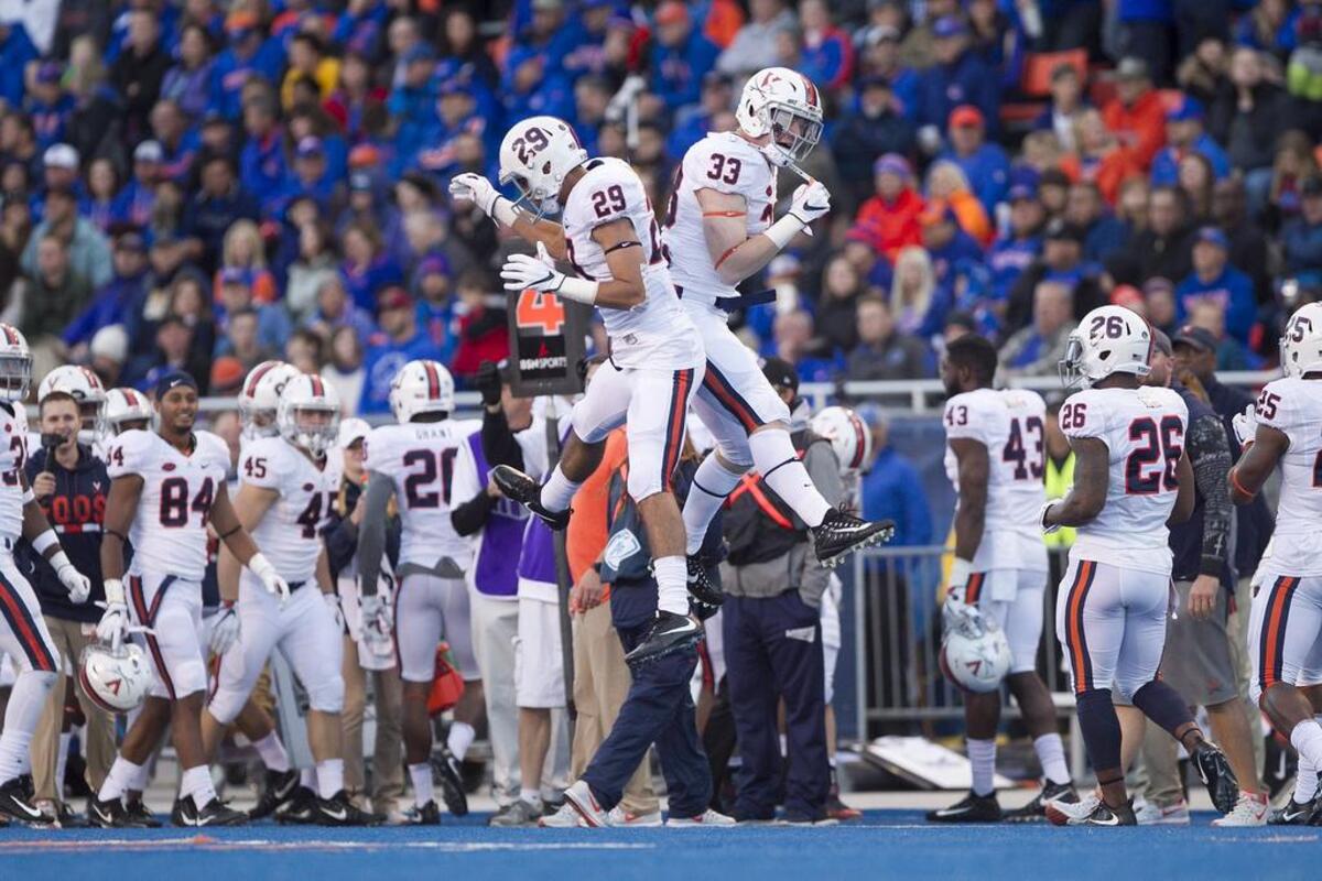 Virginia defensive back Joey Blount (29) and Virginia linebacker Zane Zandier (33) celebrate a fourth down fake punt stop against BSU during the first half of the game at Albertsons Stadium in Boise. UVA leads BSU 21-14 at the half. Friday September, 22, 2017.