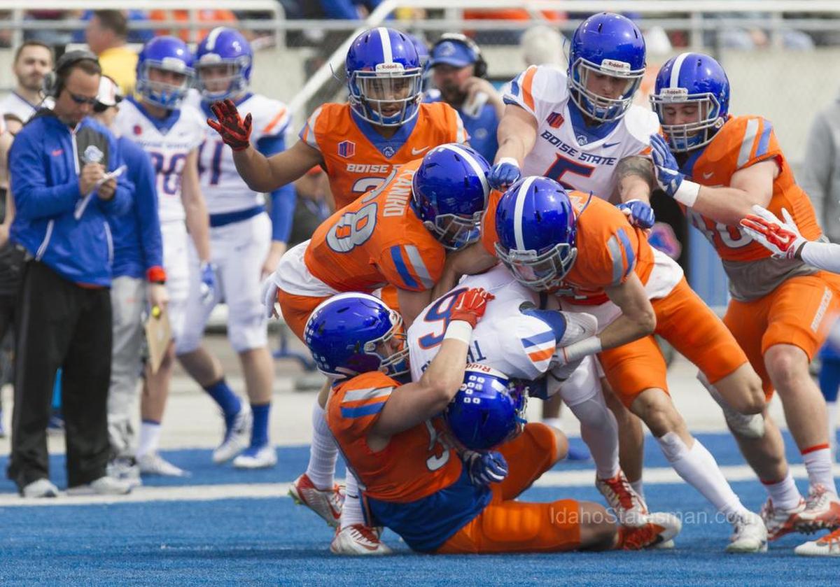 Boise State's defense gang tackles wide receiver CT Thomas at the annual Spring Game Saturday, April 14, 2018, at Albertsons Stadium in Boise.