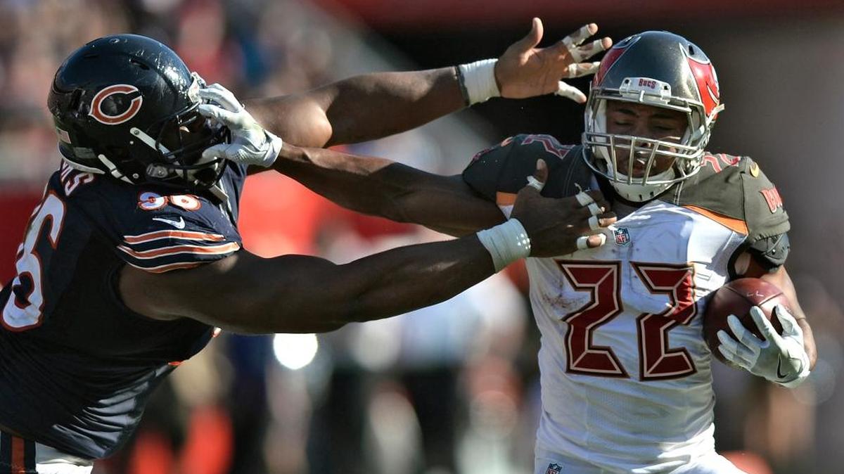 Tampa Bay Buccaneers running back Doug Martin (22) stiff arms Chicago Bears defensive end Akiem Hicks (96) on a run during the third quarter of an NFL football game Sunday, Nov. 13, 2016, in Tampa, Fla.