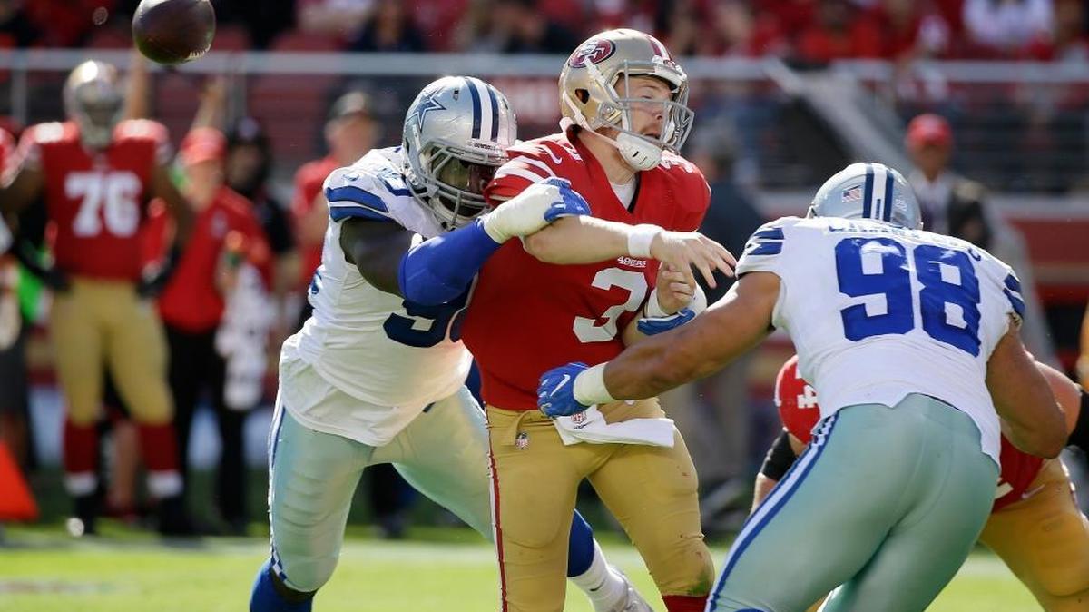 San Francisco 49ers quarterback C.J. Beathard fumbles as he is hit by Dallas Cowboys defenders Demarcus Lawrence and Tyrone Crawford on Oct. 22.