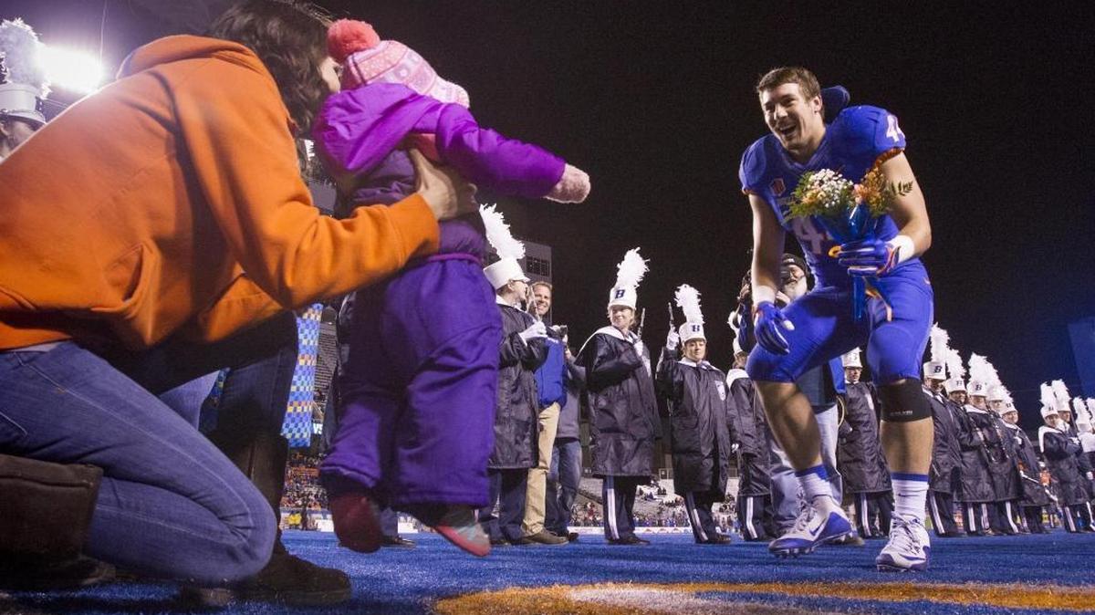 Boise State linebacker Darren Lee is greeted by his daughter Adalyn, 1, and wife Gabi Lee on senior night Nov. 18 at Albertsons Stadium. Lee committed to BSU in 2010, completed a two-year mission and has played 52 games on defense and special teams. The criminal justice major and multi-time academic All-Mountain West selection graduated Dec. 17 and intends to enter the police academy in January.