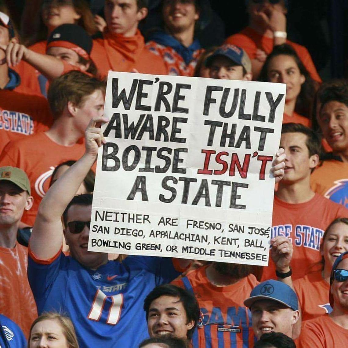 Greg Hart holds the sign he made for the Boise State-New Mexico game.