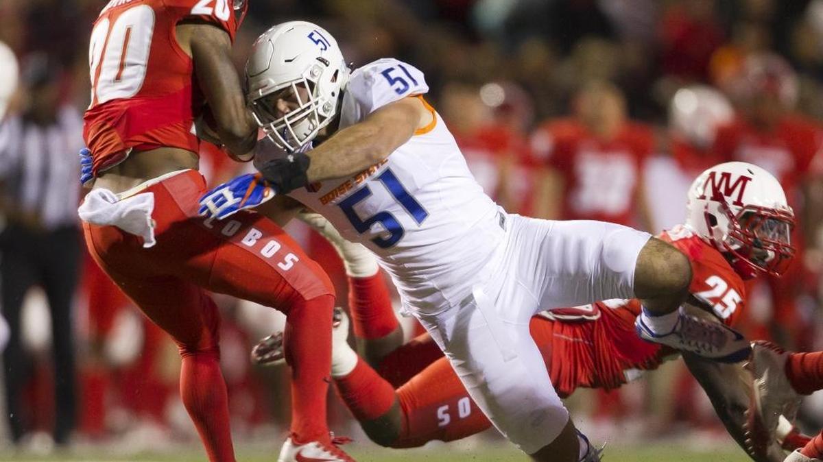 Boise State linebacker Ben Weaver (51) brings down New Mexico running back Daryl Chestnut (20) on Friday at University Stadium in Albuquerque, N.M.