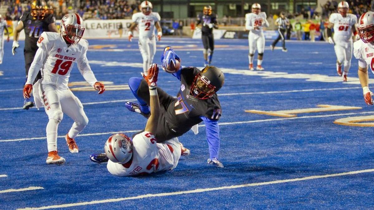 Boise State wide receiver Austin Cottrell is tackled by New Mexico safety Markel Byrd 4 yards short of scoring as the time runs off the clock Saturday at Albertsons Stadium. The Lobos defeated the Broncos 31-24.