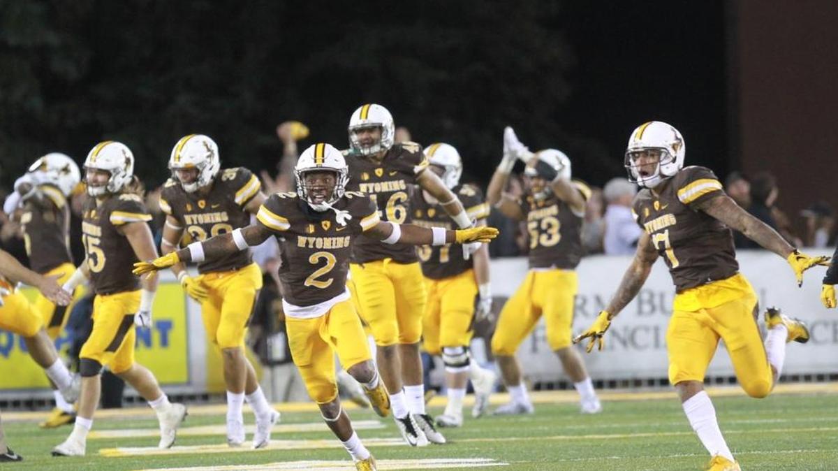 Wyoming players celebrate a late fourth-quarter safety that resulted in the winning points against Boise State at War Memorial Stadium in Laramie, Wyo., on Saturday, Oct. 29, 2016.