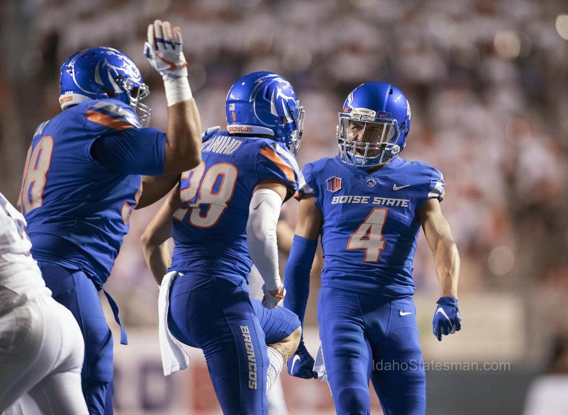 Boise State safety DeAndre Pierce (4) celebrates a tackle for loss against UConn with nickel Kekaula Kaniho (29) in the Broncos’ home opener.