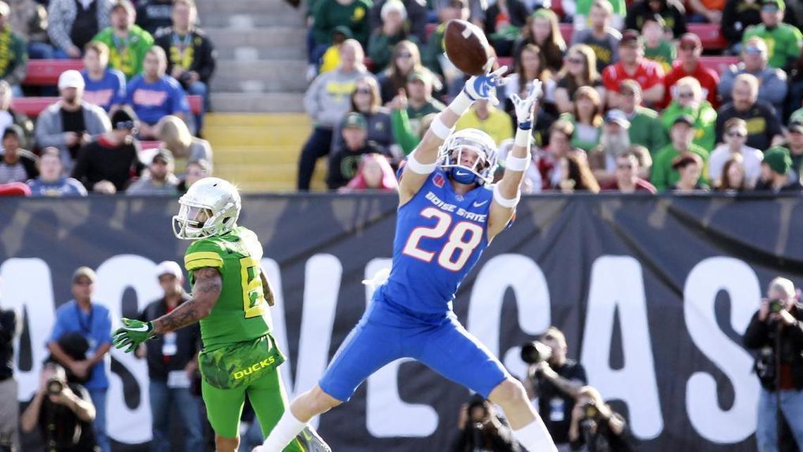 Boise State safety Kekaula Kaniho (28) makes a first-half interception that he returned for a touchdown against Oregon in the Las Vegas Bowl at Sam Boyd Stadium in Las Vegas on Saturday.