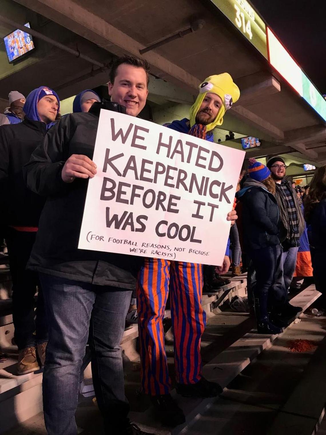 Greg Hart, left, holds the sign he made for the Boise State-Nevada game that became a sensation on Twitter.