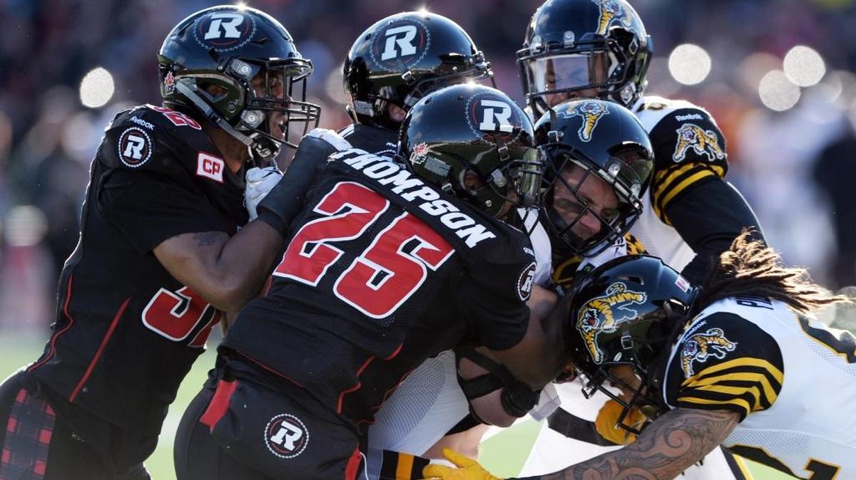 Ottawa Redblacks’ Brandyn Thompson (25) and teammates try to tackle Hamilton Tiger-Cats’ Andy Fantuz during first-half action in the CFL East Division football final in Ottawa, Ontario, Sunday, Nov. 22, 2015.