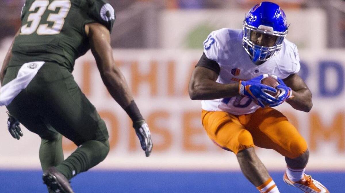 Boise State running back Jeremy McNichols (13) looks for yardage against Colorado State linebacker Kevin Davis (33) during a Mountain West game Saturday Oct. 15, 2016 at Albertsons Stadium in Boise.