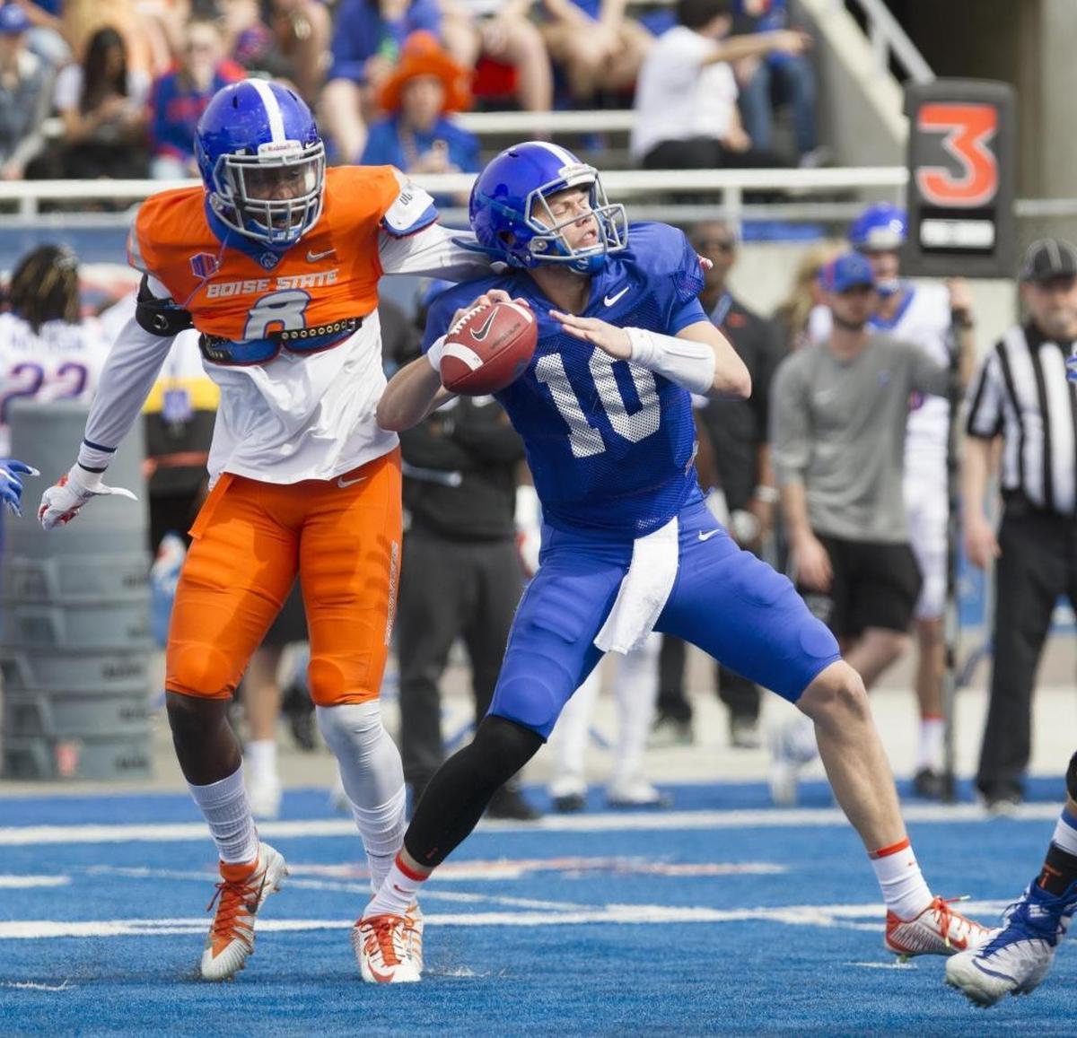 Boise State STUD Jabril Frazier taps quarterback Chase Cord on the back to let him know he has been sacked during the annual spring game.