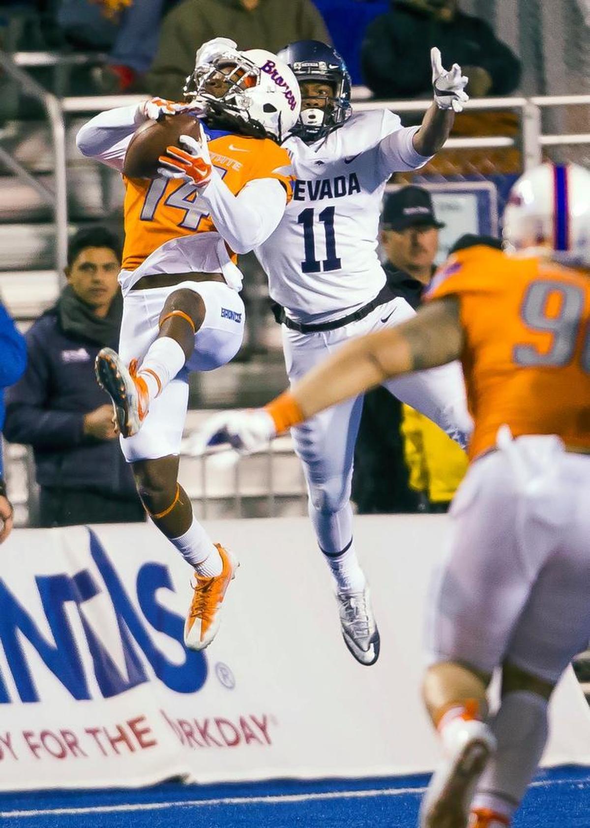 Boise State cornerback Tyler Horton intercepts a pass intended for Nevada wide receiver Daiyan Henley in the fourth quarter last week at Albertsons Stadium in Boise.