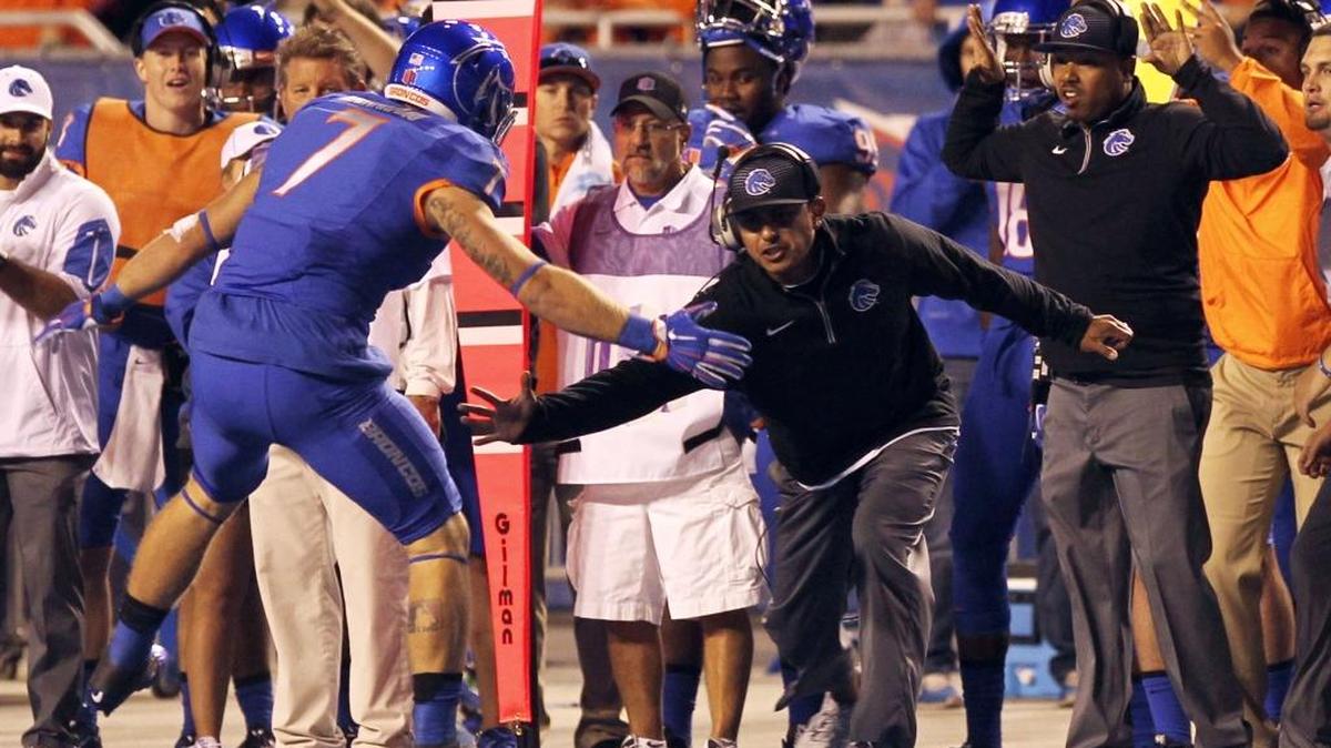 Andy Avalos, shown celebrating with linebacker Joe Martarano during a game last season, was promoted to defensive coordinator in the offseason. “I'm really excited. There’s always been high expectations for our defense when I played to now, so I’m looking forward to upholding that.’’