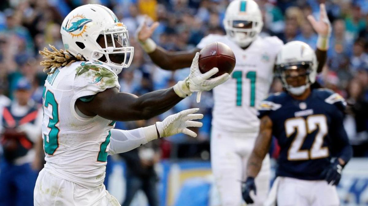 Miami Dolphins running back Jay Ajayi, left, celebrates after scoring during the second half in an NFL football game against the San Diego Chargers, Sunday, Dec. 20, 2015, in San Diego.