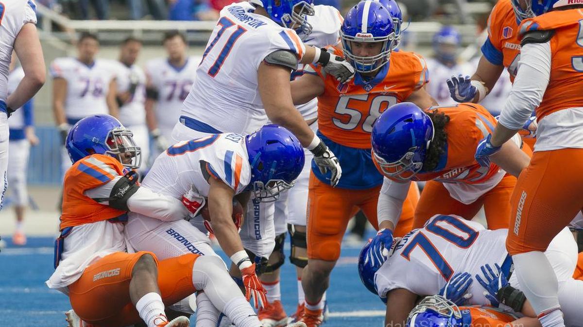 Boise State STUD Jabril Frazier wraps up running back Drake Beasley at the line of scrimmage during the annual Spring Game Saturday, April 14, 2018 at Albertsons Stadium in Boise.