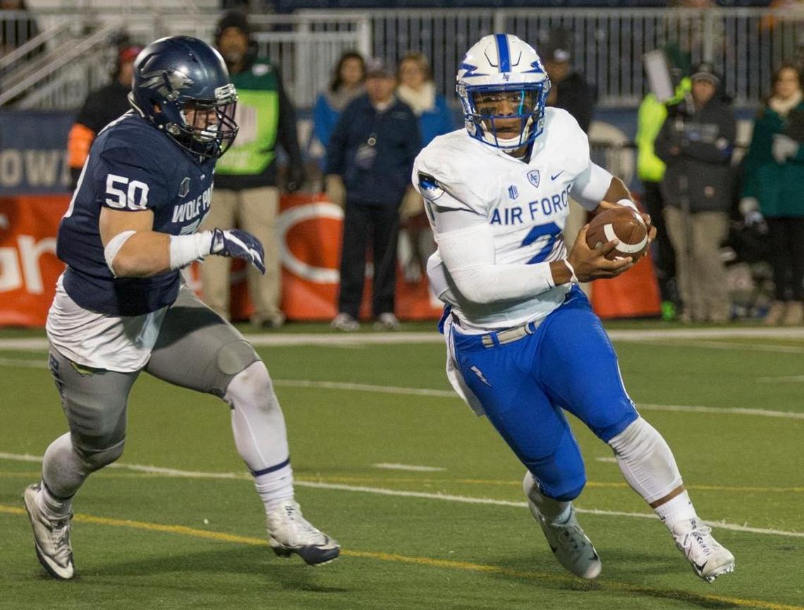 Air Force quarterback Arion Worthman, right, runs away from Nevada’s Austin Paulhus in the second half Oct. 20 in Reno, Nev.