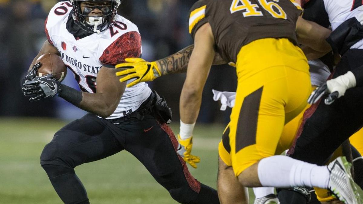 San Diego State’s Rashaad Penny runs for yardage against Wyoming during the first half of an NCAA college football game Saturday, Dec. 3, 2016, in Laramie, Wyo.