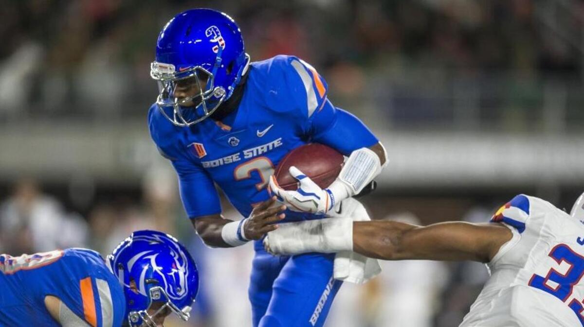 Boise State quarterback Montell Cozart tries to break the grasp of Colorado State linebacker Emmanuel Jones during the first quarter Saturday in Fort Collins, Colo.