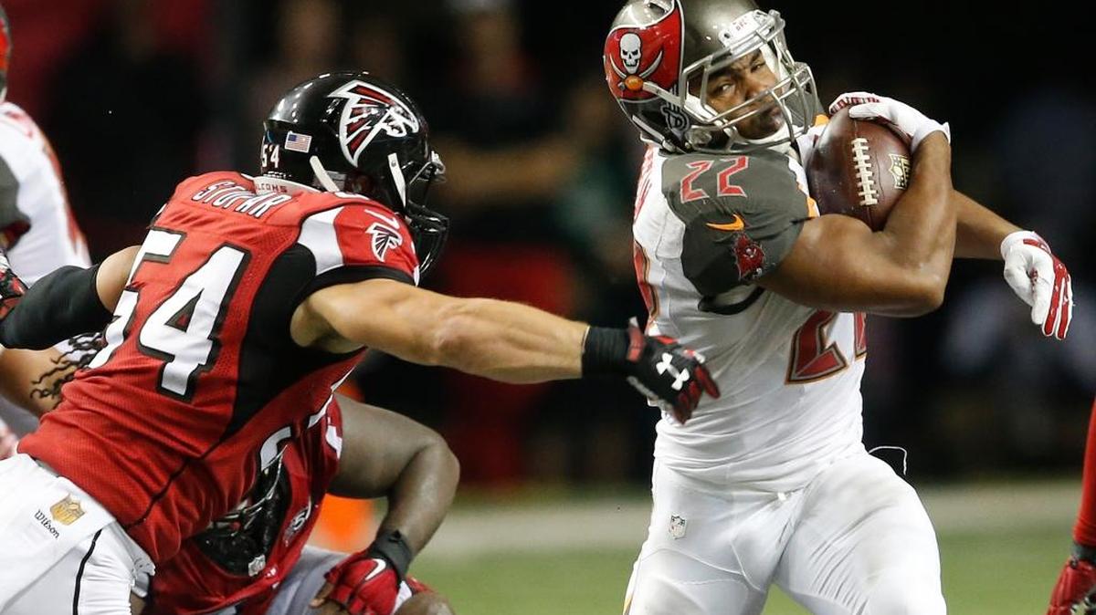 Tampa Bay Buccaneers running back Doug Martin (22) runs as Atlanta Falcons outside linebacker Nate Stupar (54) defends during overtime of an NFL football game, Sunday, Nov. 1, 2015, in Atlanta.