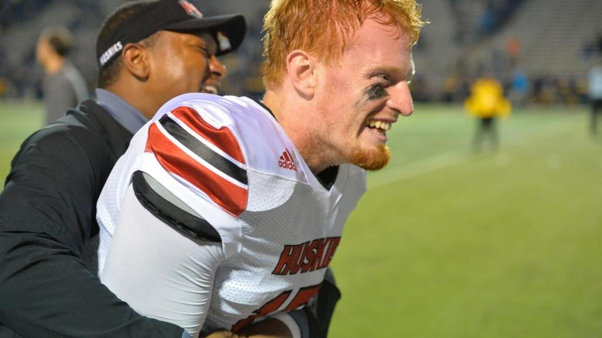 Northern Illinois quarterback Ryan Graham and a coach celebrate last month’s victory over Toledo.