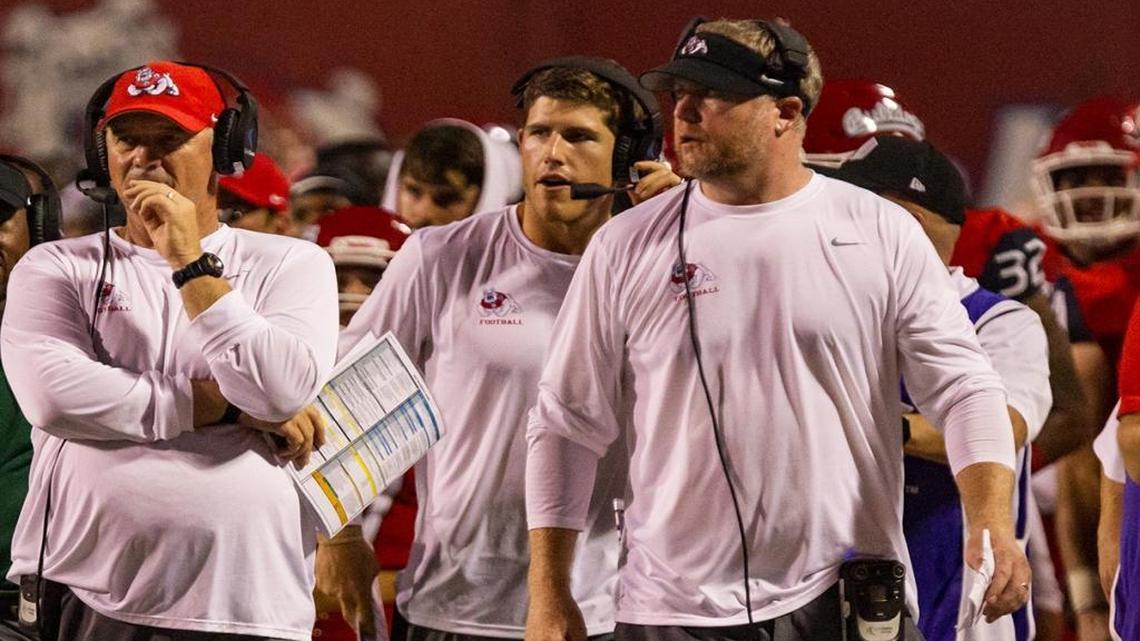 Fresno State receivers coach Kirby Moore, middle, is a former Boise State player.